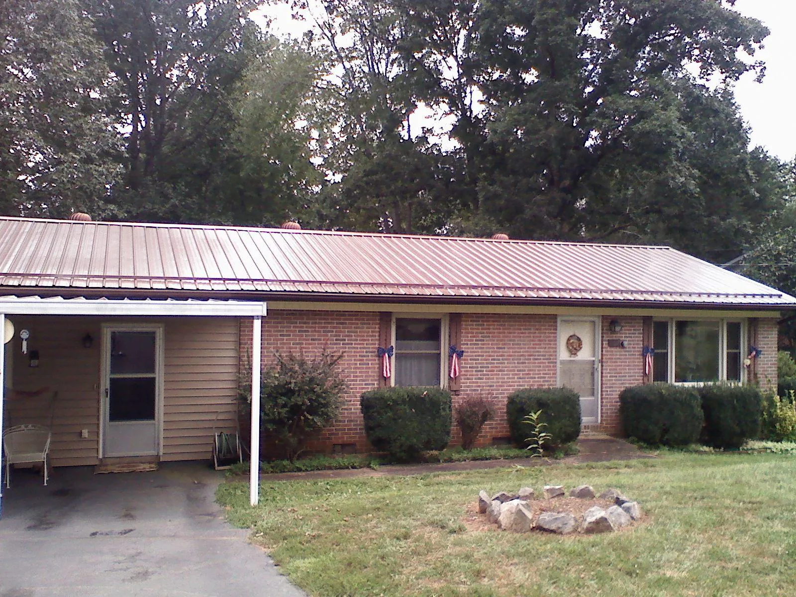 Bronze metal roof and carport on a brick ranch home — Roof Repair work by our crew in Agawam