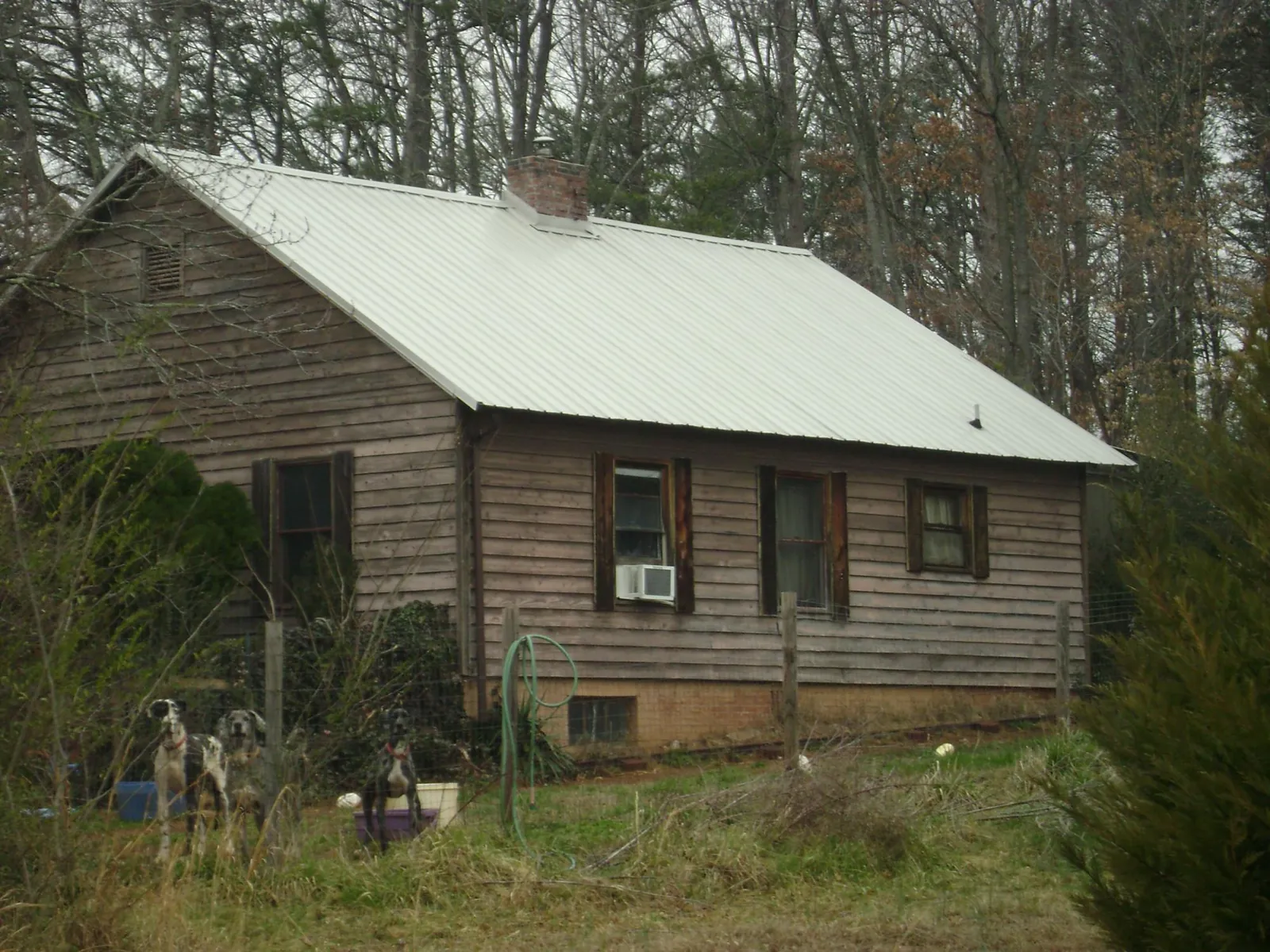 White metal roof on an old wood sided farmhouse, from a Metal Roof Installation job in Agawam